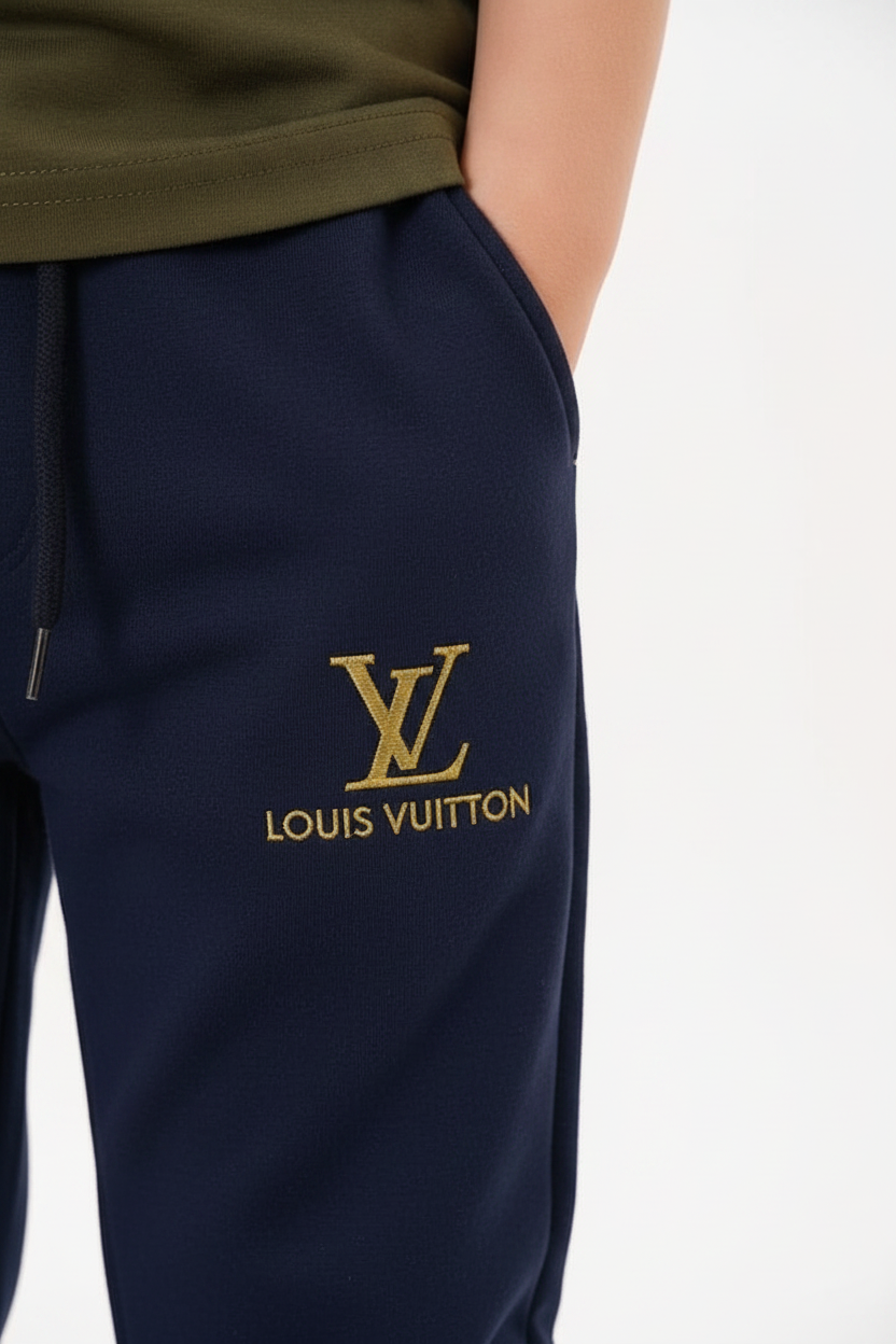 Détail monogramme doré style LV sur la jambe du jogging bleu marine enfant